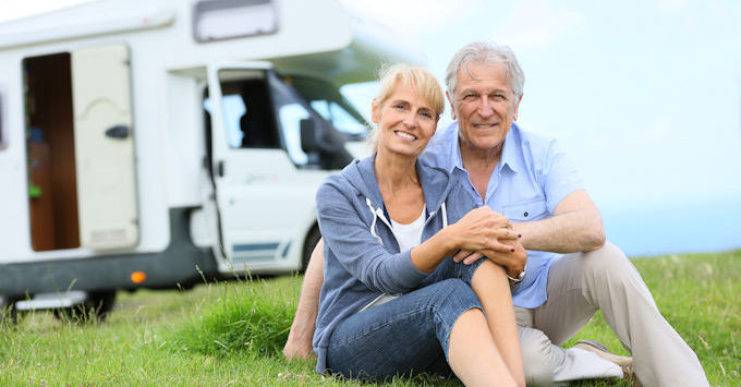 couple sitting outside camper